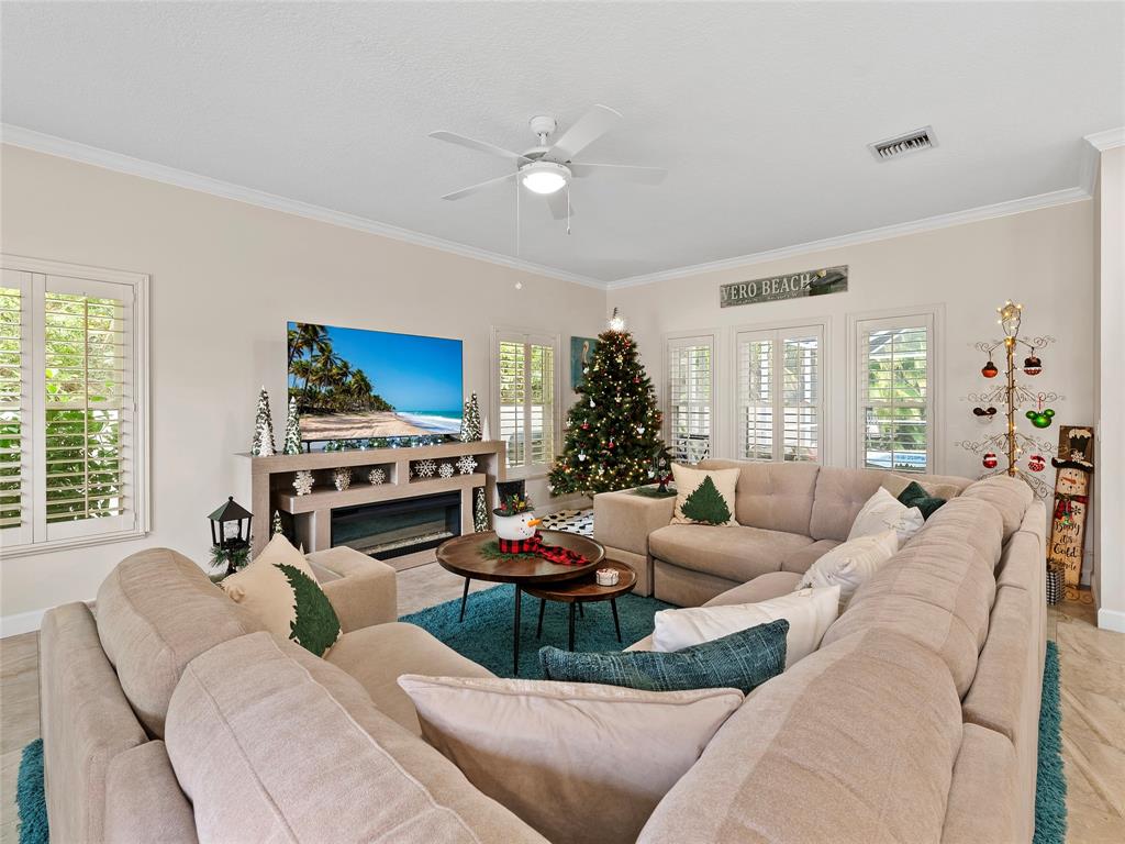 4480 23rd Way Vero Beach, FL 32966 - Photo 2 of 29 a living room with furniture fireplace and a large window