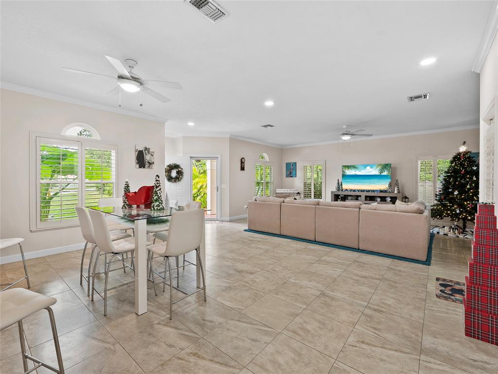 4480 23rd Way Vero Beach, FL 32966 - Photo 6 of 29 a living room with furniture and a dining table with kitchen view