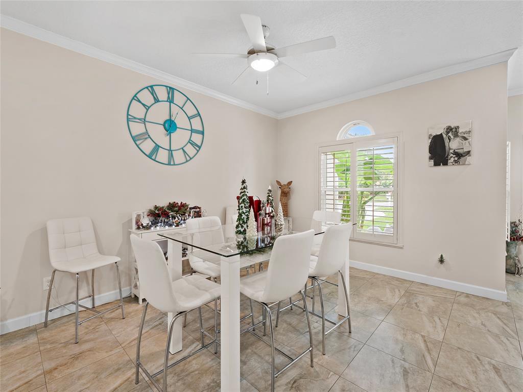 4480 23rd Way Vero Beach, FL 32966 - Photo 7 of 29 a view of a dining room with furniture and a large window