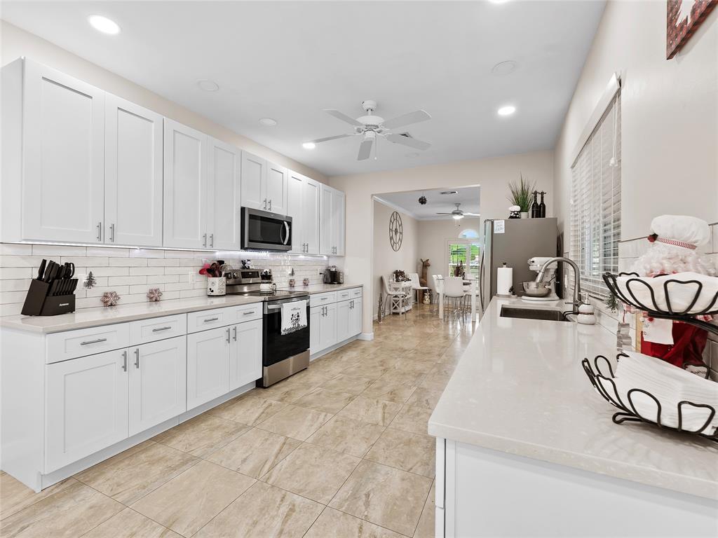 4480 23rd Way Vero Beach, FL 32966 - Photo 10 of 29 a kitchen with sink and white cabinets
