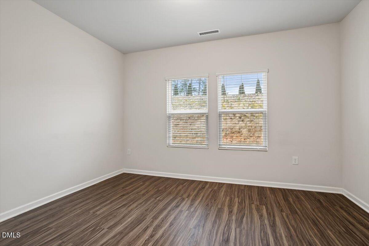 46 Coffee Tree Circle Clayton, NC 27527 - Photo 16 of 36 an empty room with wooden floor and windows