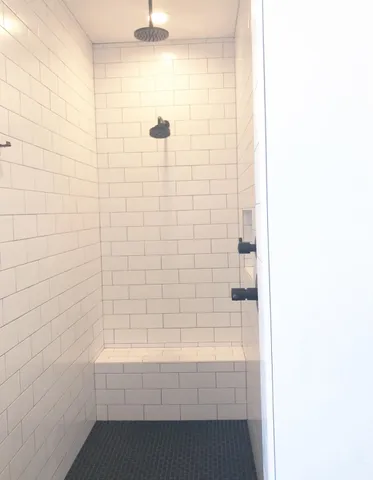 a bathroom with a bathtub and shower