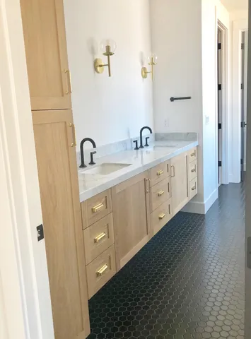 a spacious bathroom with a double vanity sink and mirror