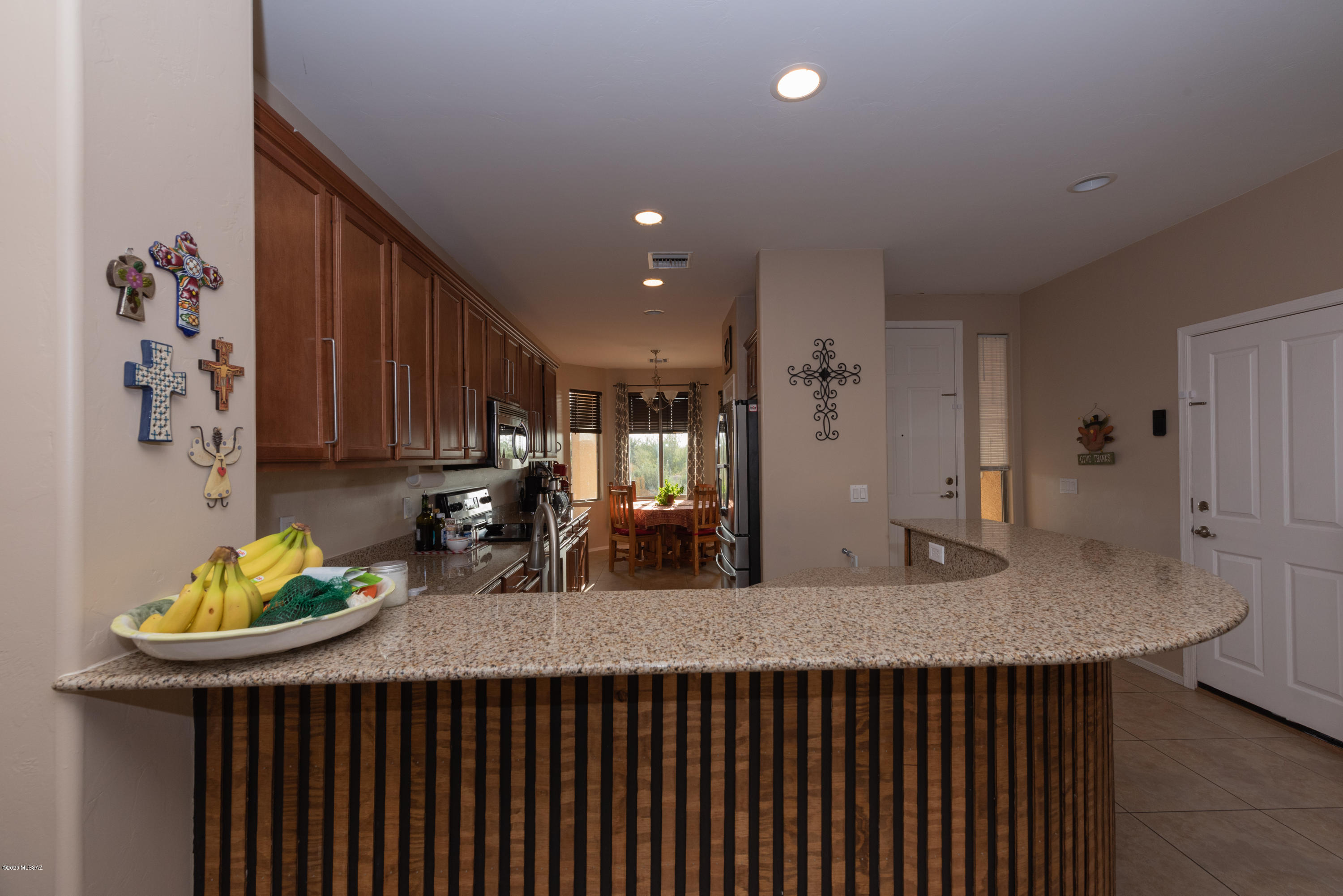 12910 Bloomington Loop Oro Valley, AZ 85755 - Photo 6 of 30 a kitchen with a table and chairs in it