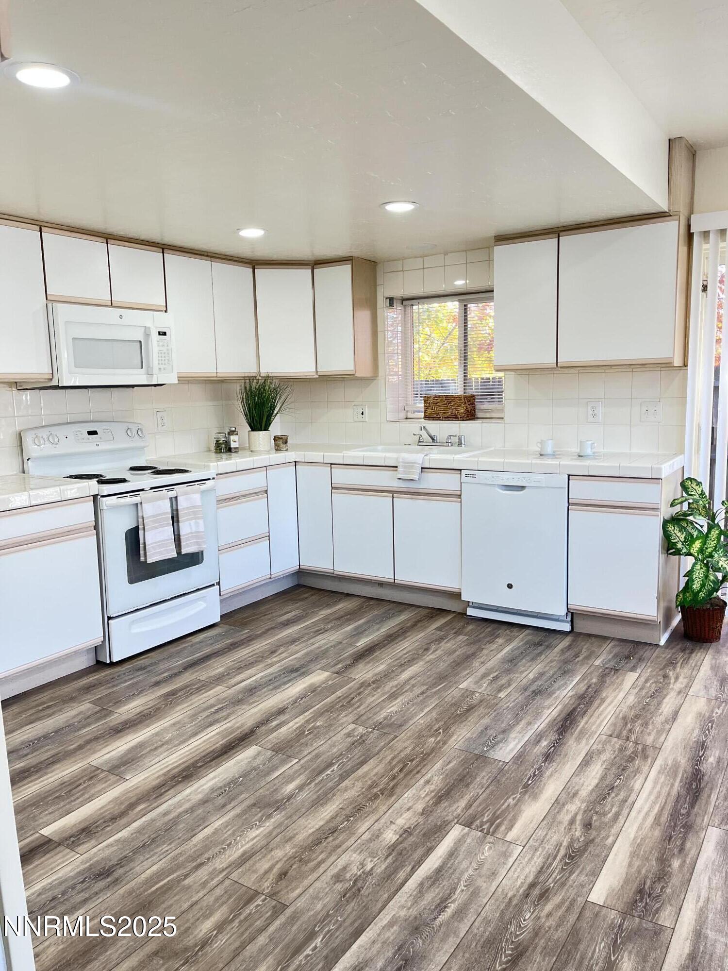 506 East Taylor Street Reno, NV 89502 - Photo 2 of 12 a large kitchen with stainless steel appliances granite countertop a stove a sink and a refrigerator