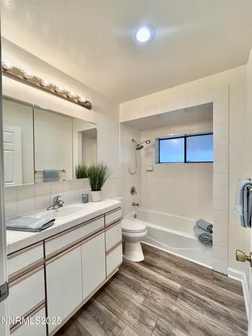 a bathroom with a double vanity sink mirror and toilet