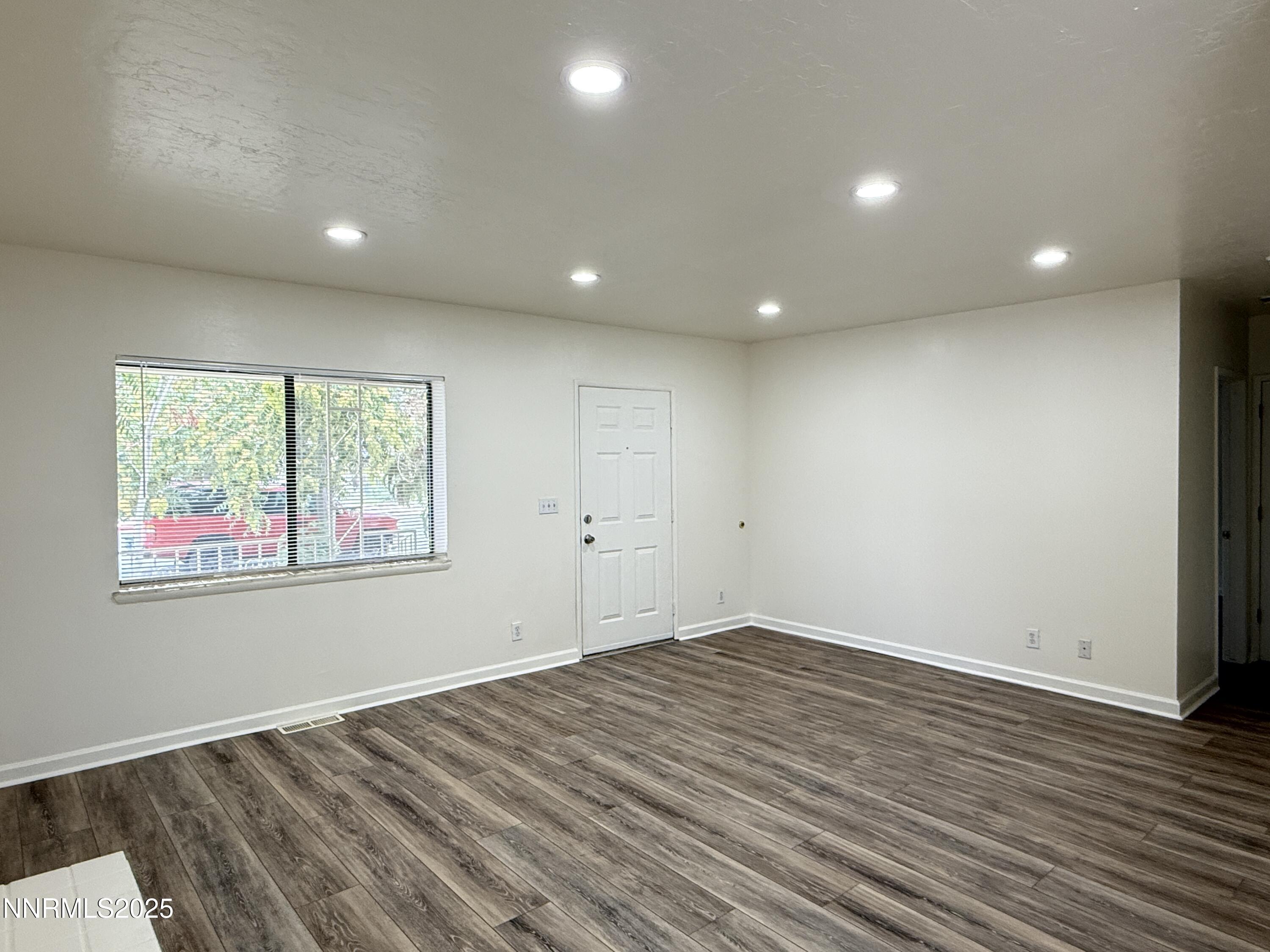 506 East Taylor Street Reno, NV 89502 - Photo 6 of 12 an empty room with wooden floor and windows