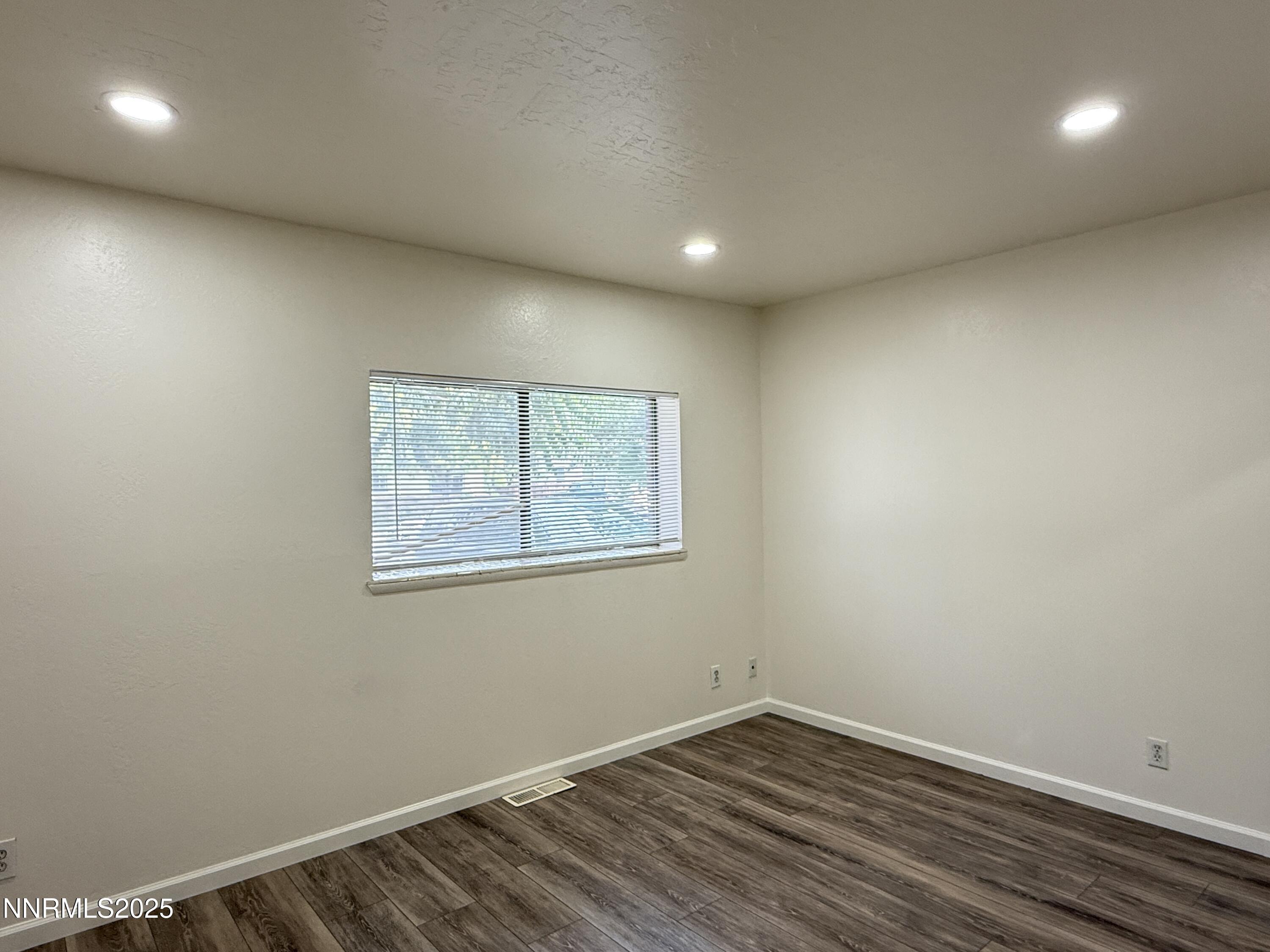 506 East Taylor Street Reno, NV 89502 - Photo 7 of 12 an empty room with wooden floor and windows