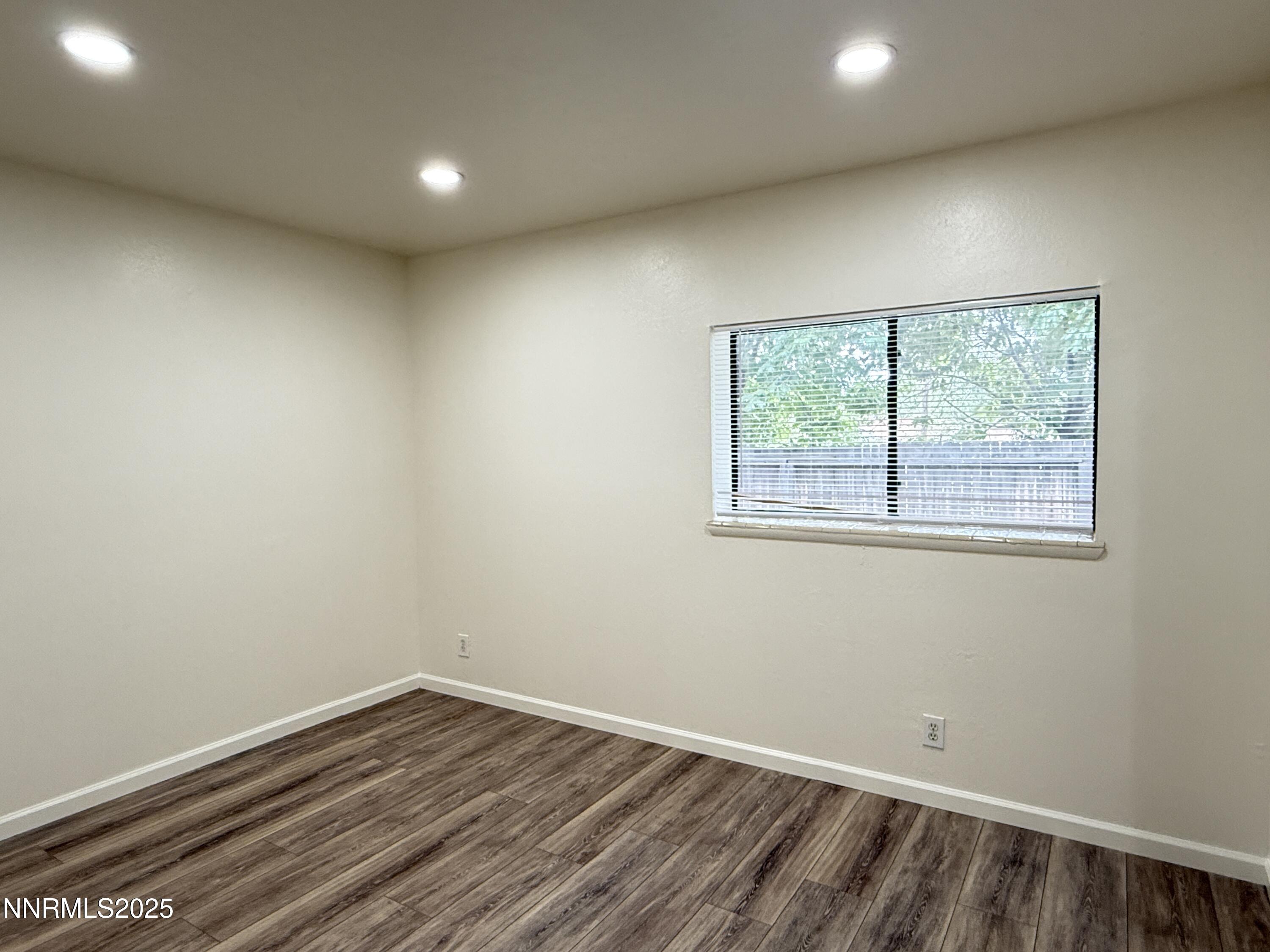 506 East Taylor Street Reno, NV 89502 - Photo 8 of 12 an empty room with wooden floor and windows