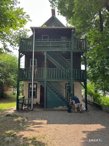 a view of a house with a patio and a yard