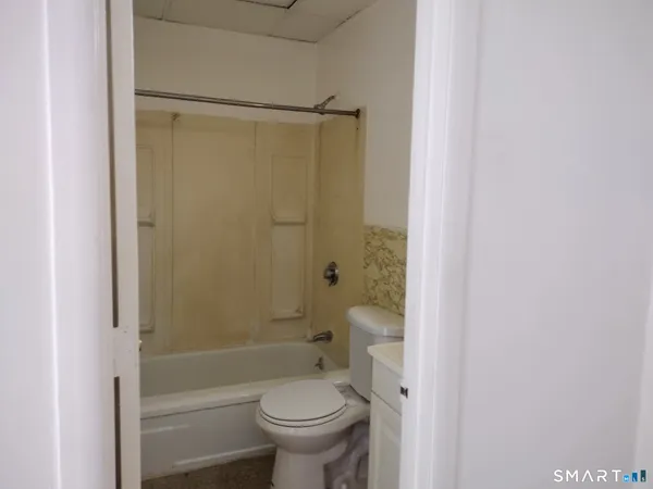 a bathroom with a shower a toilet and a shower