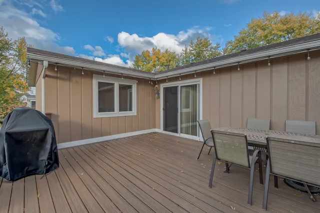 a view of a deck with table and chairs and wooden floor