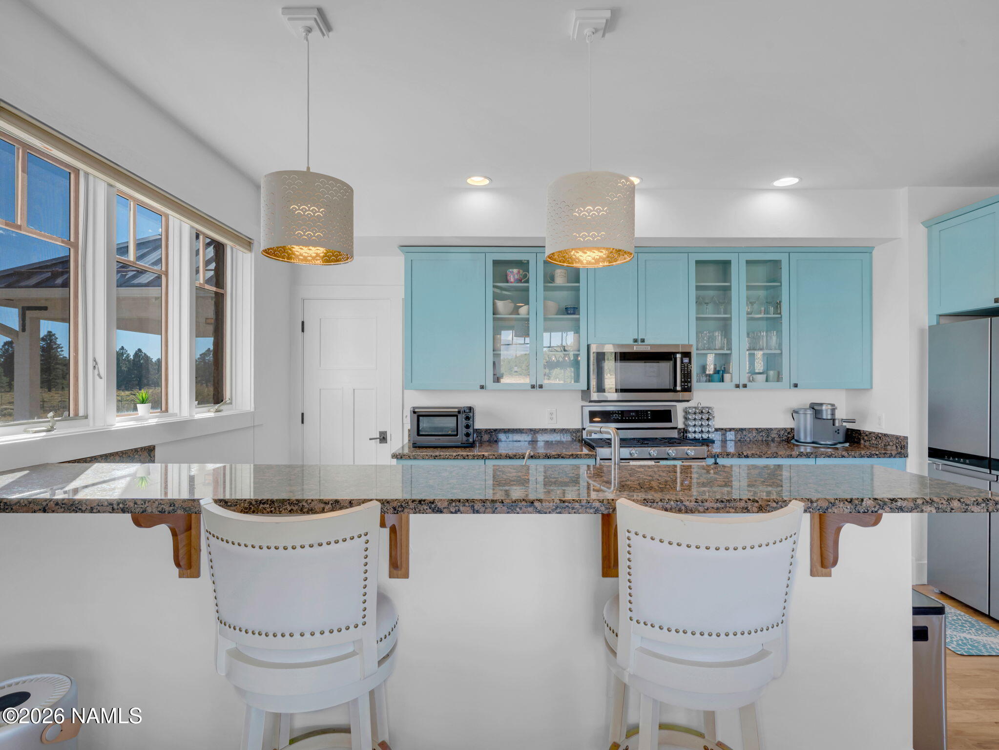 15739 Rabbit Brush Road Parks, AZ 86018 - Photo 23 of 67 a kitchen with a stove a sink a center island and cabinets