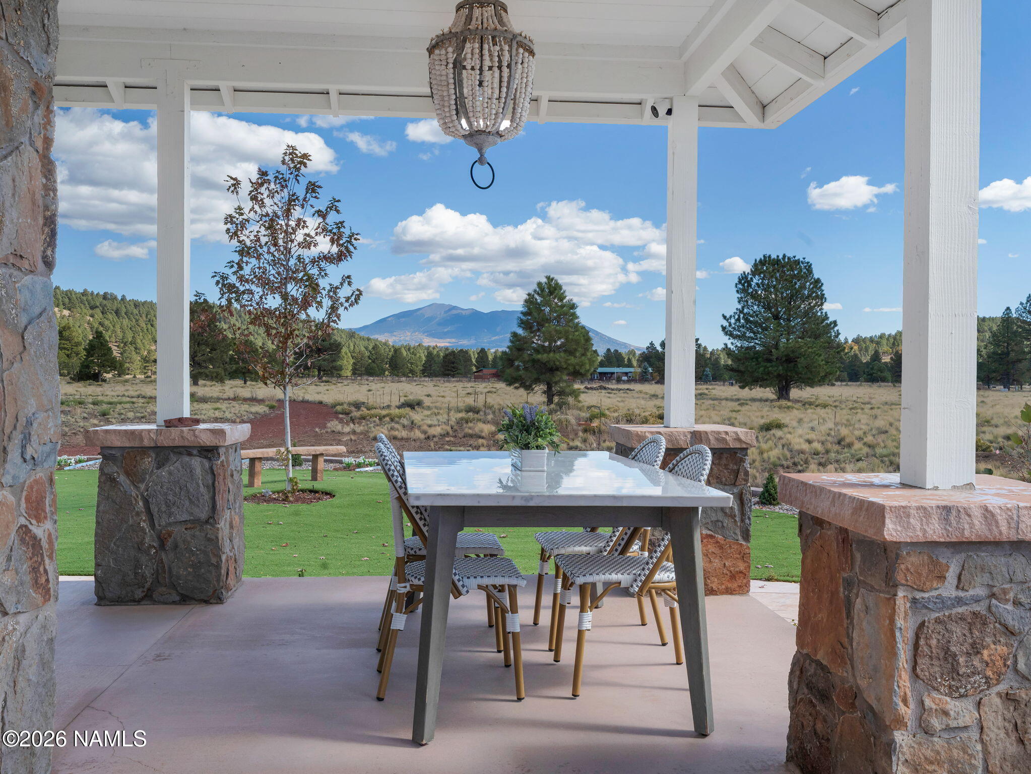 15739 Rabbit Brush Road Parks, AZ 86018 - Photo 8 of 67 a view of a patio with a table chairs and a fire pit