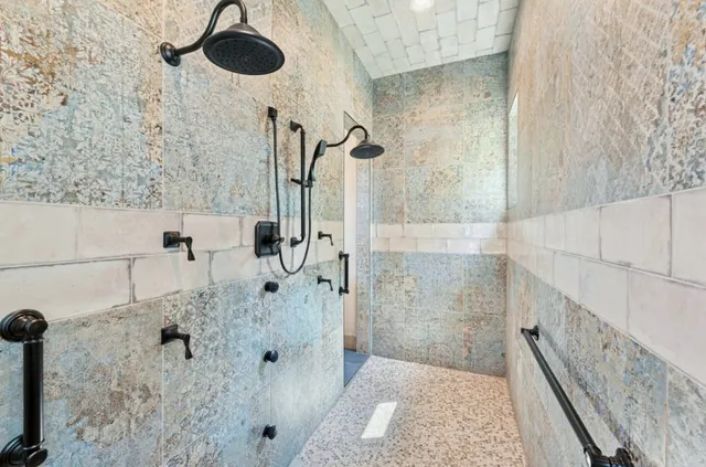 a bathroom with a granite countertop shower