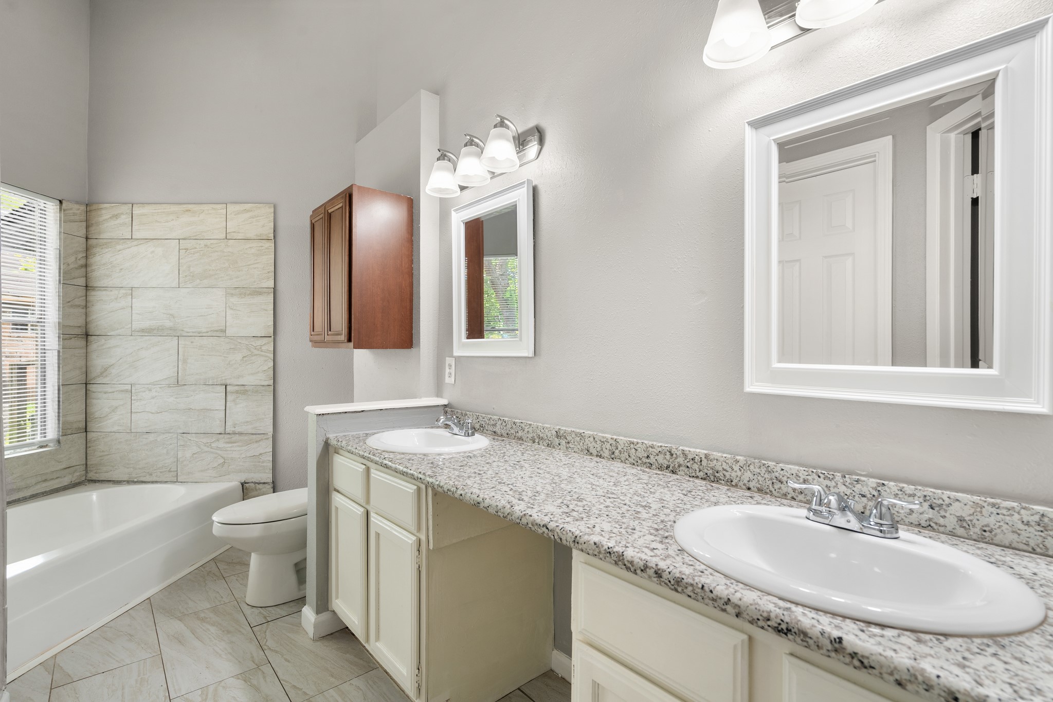2220 Spruce Drive Rosenberg, TX 77471 - Photo 11 of 18 The primary bathroom is equipped with dual sinks, offering added convenience and functionality.