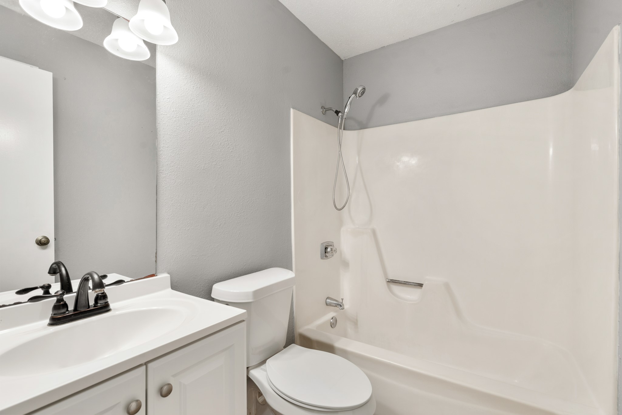 2220 Spruce Drive Rosenberg, TX 77471 - Photo 14 of 18 A shared bathroom serves the secondary bedrooms, offering practical convenience for the home.