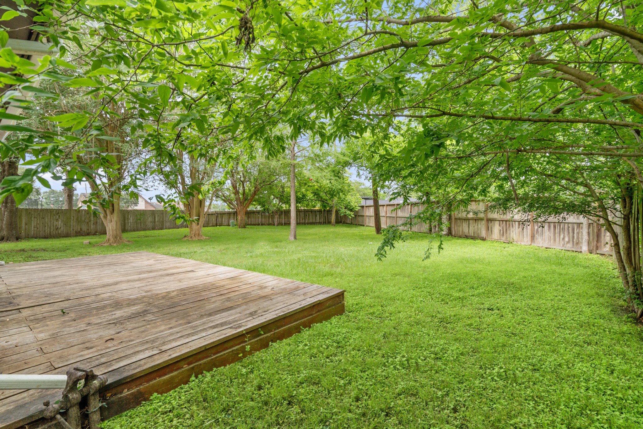 2220 Spruce Drive Rosenberg, TX 77471 - Photo 15 of 18 An oversized fenced backyard provides plenty of space for outdoor enjoyment, complemented by a deck ideal for relaxing or entertaining.