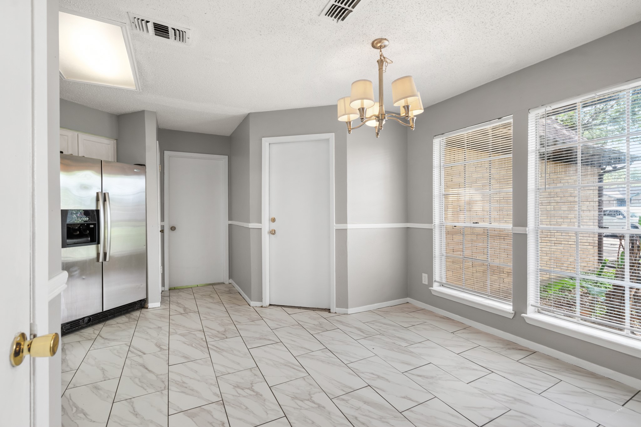 2220 Spruce Drive Rosenberg, TX 77471 - Photo 5 of 18 The kitchen features tile flooring and is filled with natural light from large windows.