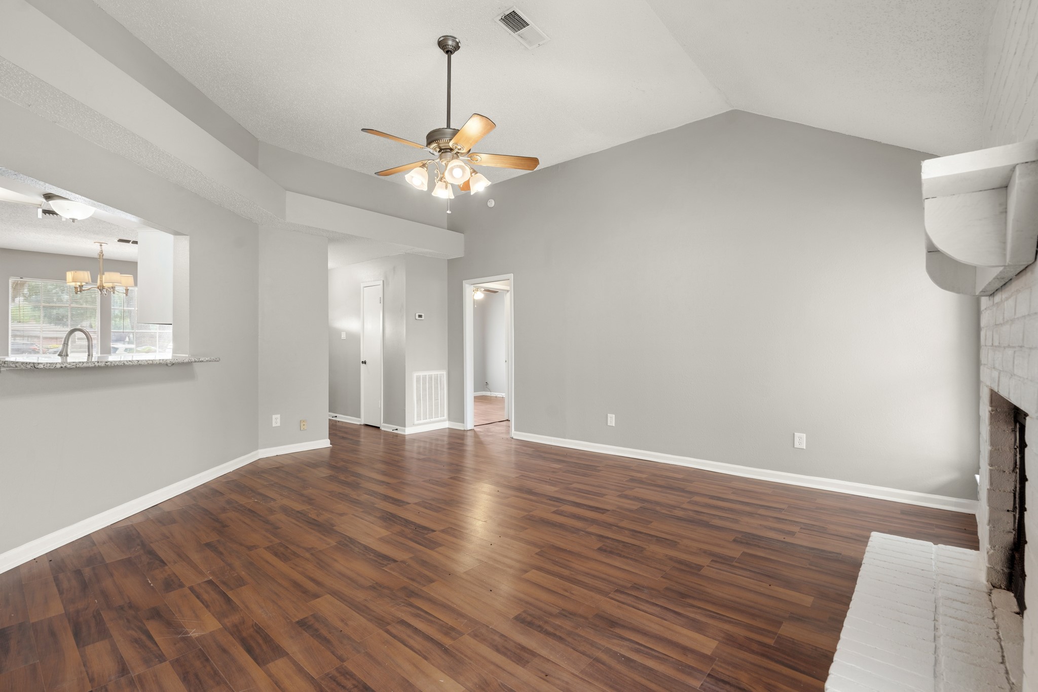 2220 Spruce Drive Rosenberg, TX 77471 - Photo 8 of 18 The living room features wood-like flooring, adding warmth and a modern touch to the space.