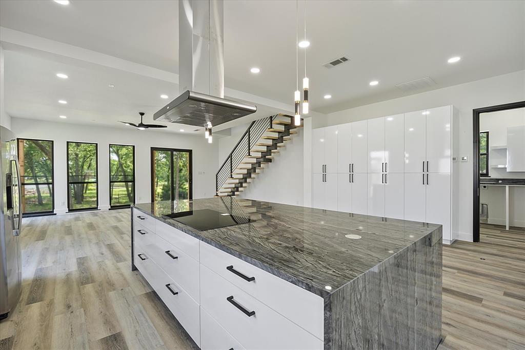2811 Rodeo Drive Quinlan, TX 75474 - Photo 7 of 35 Kitchen with modern cabinets, island range hood, black electric stovetop, light wood finished floors, and recessed lighting
