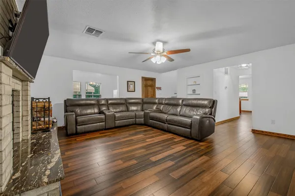 a living room with furniture and wooden floor