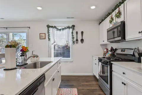 a kitchen with a sink stove and refrigerator
