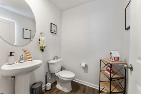 a bathroom with a sink toilet and a mirror