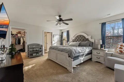 a bedroom with bed window and couch