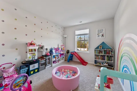 a living room with furniture and a book shelf