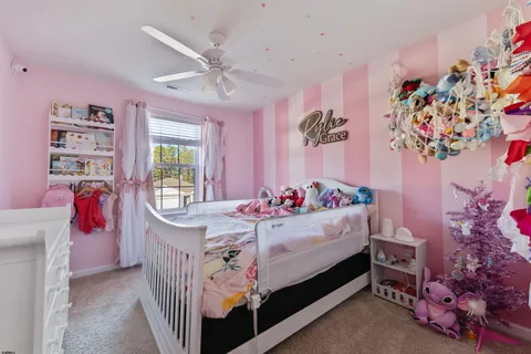 a bed room with a bed mirror and a window