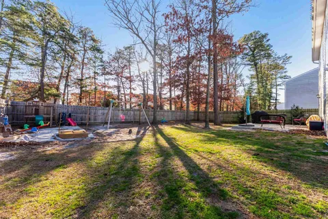 a view of swimming pool with outdoor seating and covered with trees