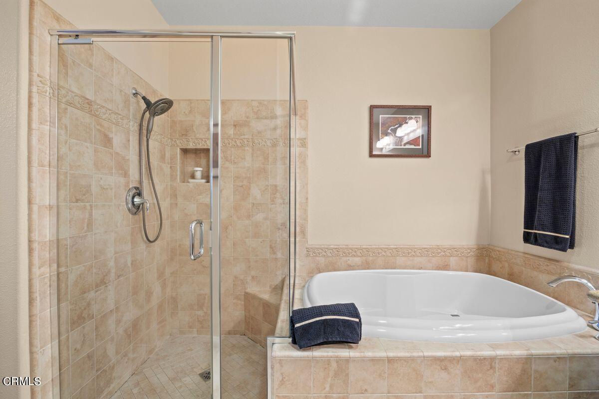 3004 Moonlight Park Avenue Oxnard, CA 93036 - Photo 14 of 28 a bathroom with a bath tub and a shower