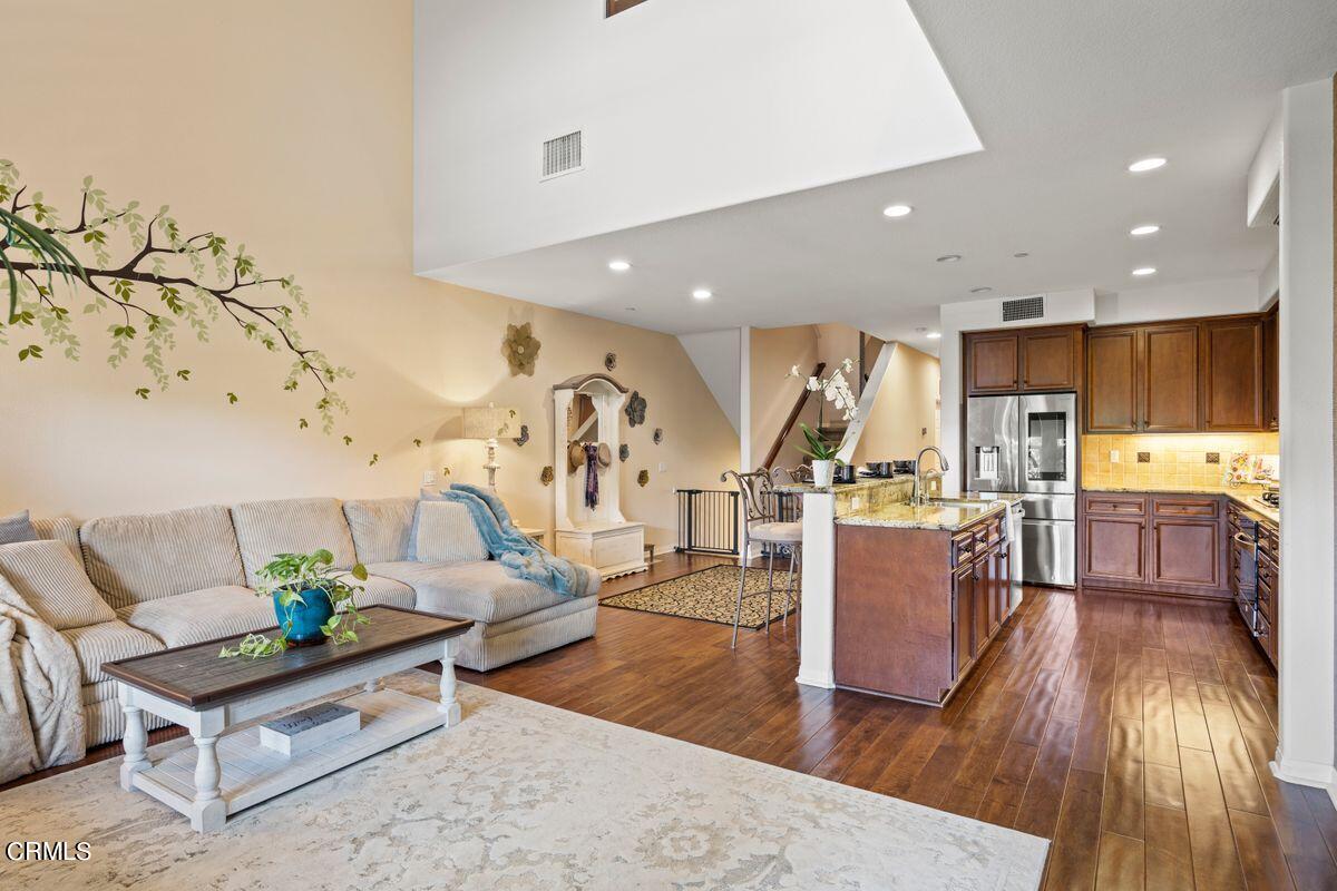 3004 Moonlight Park Avenue Oxnard, CA 93036 - Photo 4 of 28 a living room with furniture and kitchen view with wooden floor