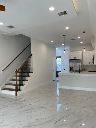 a view of front door and hallway with wooden floor