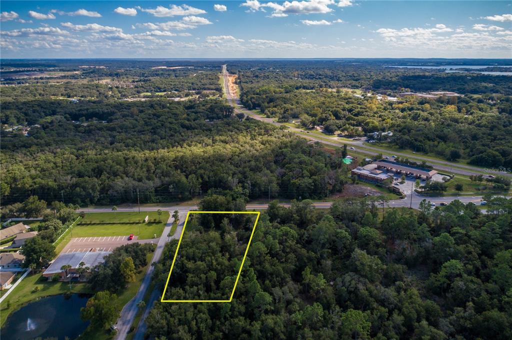 an aerial view of residential houses with outdoor space and swimming pool