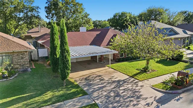 a view of a backyard with plants and a garden