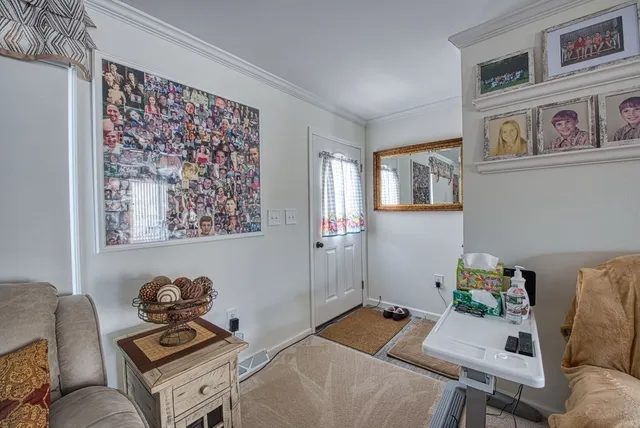 a room with furniture and paintings on the wall