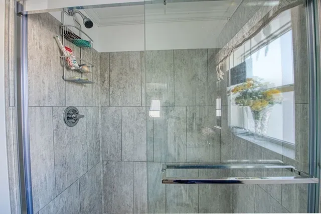 a bathroom with a glass shower door