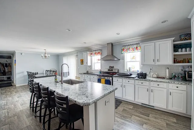 a kitchen with granite countertop cabinets countertop a sink and chairs