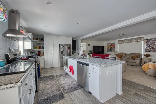 a kitchen with granite countertop a stove and a sink