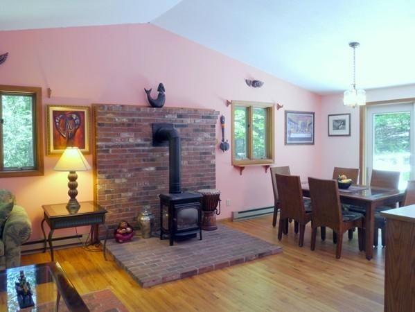 1335 Bay Road Amherst, MA 01002 - Photo 4 of 18 a living room with furniture a dining table and a fireplace