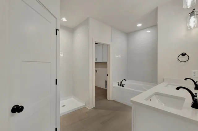 a bathroom with a tub sink and mirror