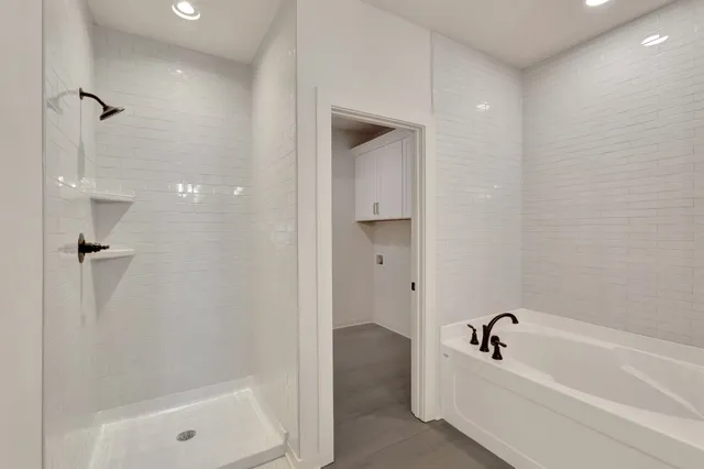 a bathroom with a bathtub and shower