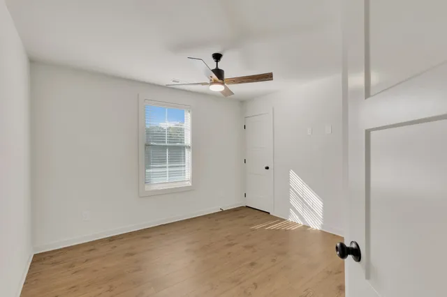 a view of a livingroom with a ceiling fan and window