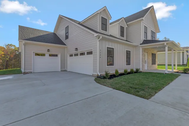 a view of a house with a yard and garage