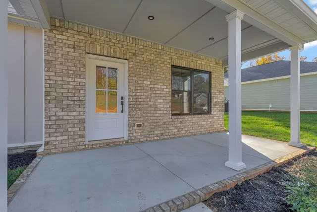 a view of a brick house with a yard