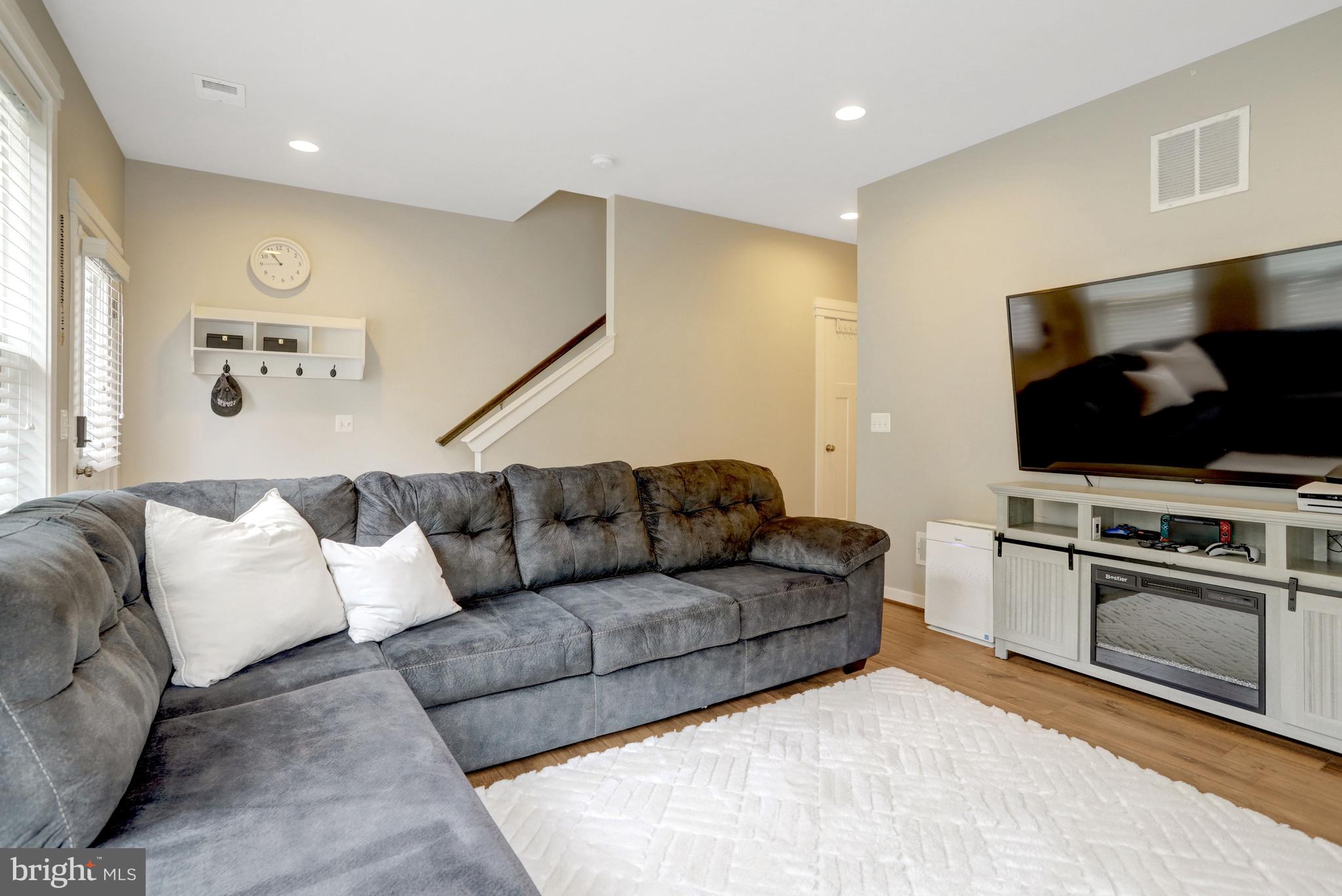 9180 Snowden Ashford Road Lorton, VA 22079 - Photo 3 of 28 a living room with furniture and a flat screen tv