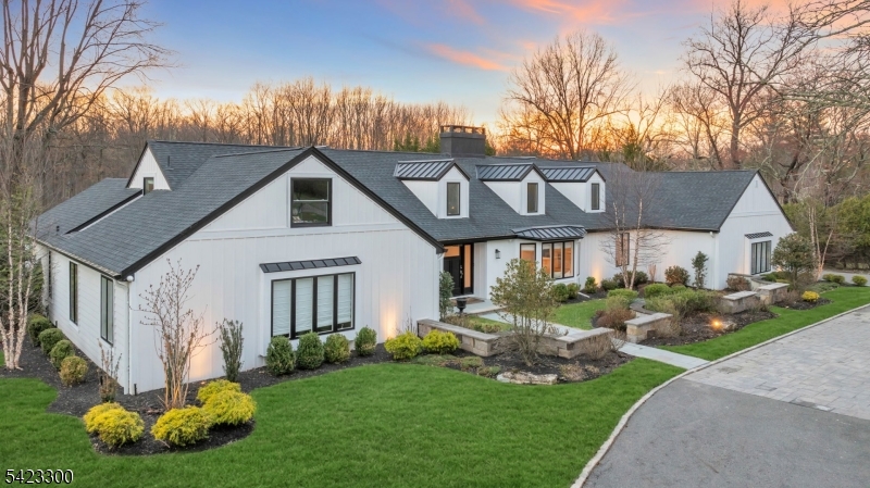 a front view of a house with a garden and plants