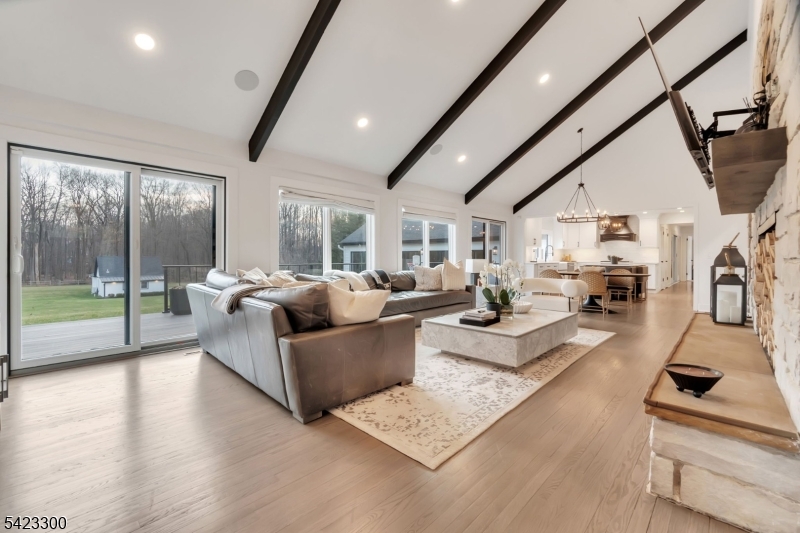 16 East Greenbrook Road North Caldwell, NJ 07006 - Photo 12 of 45 a living room with furniture floor to ceiling window and a flat screen tv